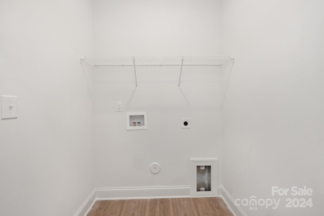 laundry area with hookup for a gas dryer, hardwood / wood-style floors, washer hookup, and hookup for an electric dryer