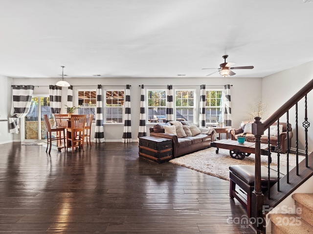 living area with wood-type flooring, stairs, and a wealth of natural light