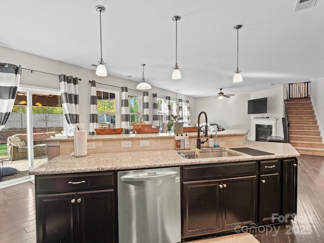 kitchen featuring a sink, wood-type flooring, open floor plan, and dishwasher