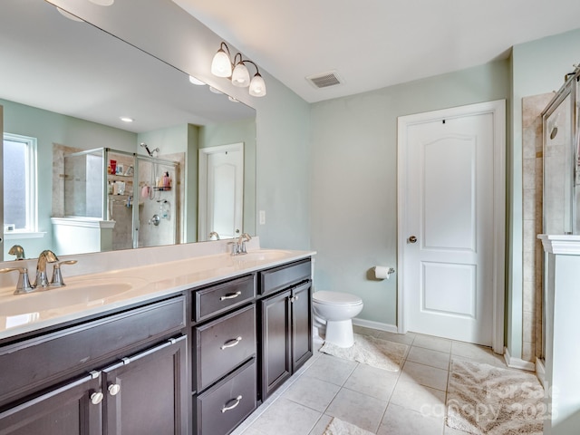 bathroom with double vanity, a stall shower, visible vents, and a sink