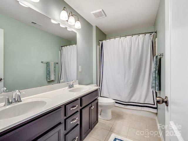 bathroom with toilet, a sink, visible vents, and tile patterned floors