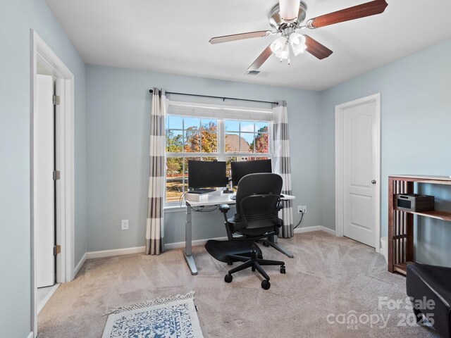 office space featuring a ceiling fan, carpet, visible vents, and baseboards