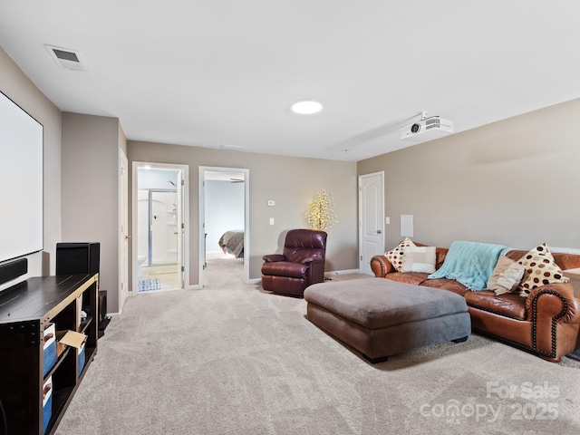 living area featuring carpet, visible vents, and baseboards