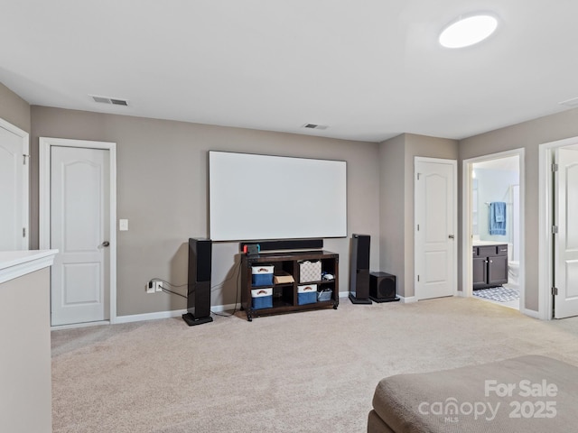 carpeted cinema with visible vents and baseboards