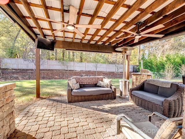 view of patio / terrace with a fenced backyard, ceiling fan, and outdoor lounge area