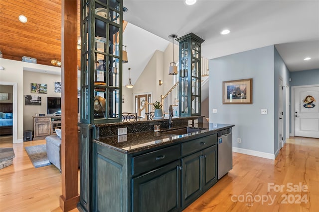 kitchen with sink, dark stone countertops, dishwasher, light hardwood / wood-style floors, and hanging light fixtures