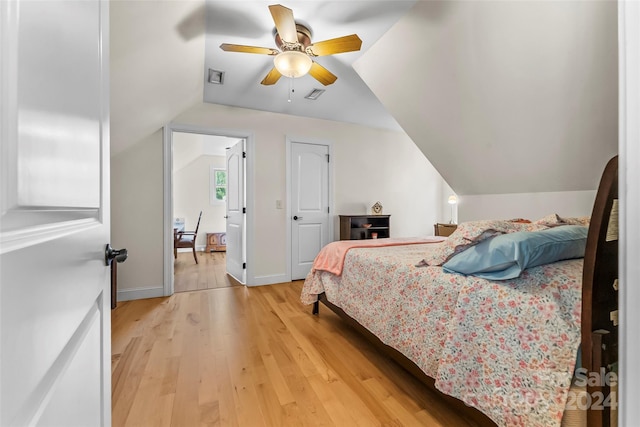 bedroom with hardwood / wood-style floors, ceiling fan, and lofted ceiling