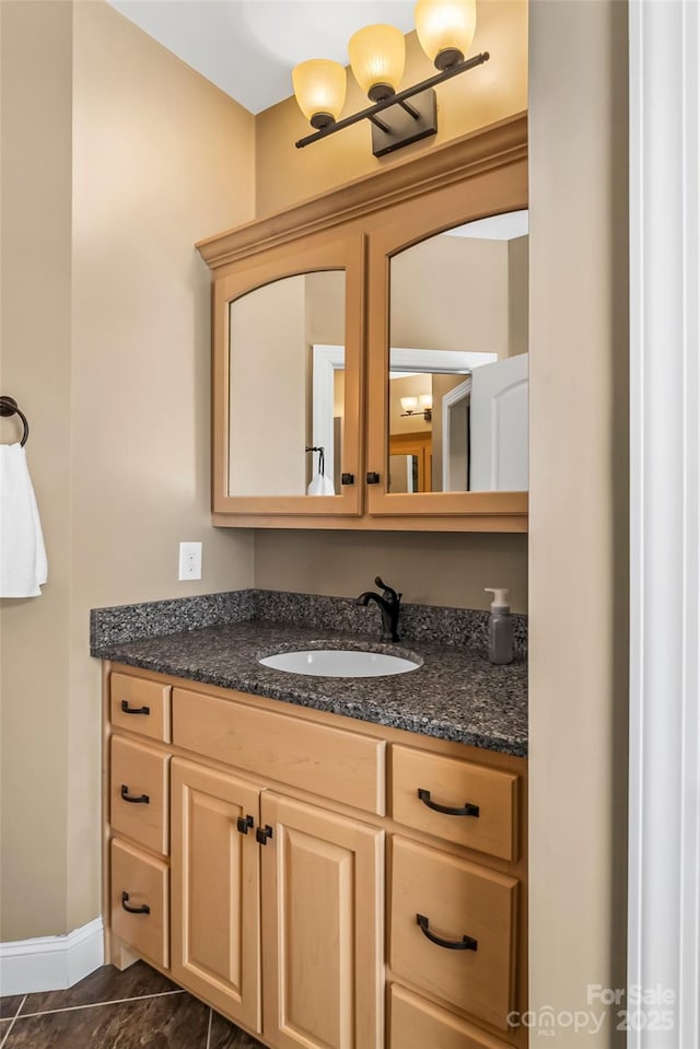 bathroom with vanity and baseboards