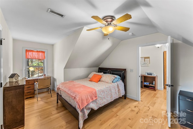 bedroom with light wood finished floors, lofted ceiling, visible vents, ceiling fan, and baseboards