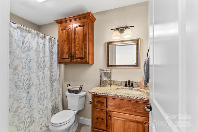 bathroom featuring curtained shower, vanity, toilet, and baseboards