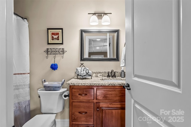 full bathroom featuring vanity and toilet