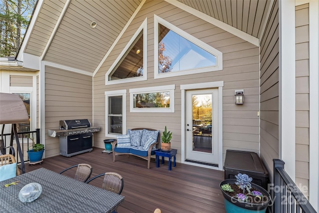 wooden terrace featuring outdoor dining area and a grill