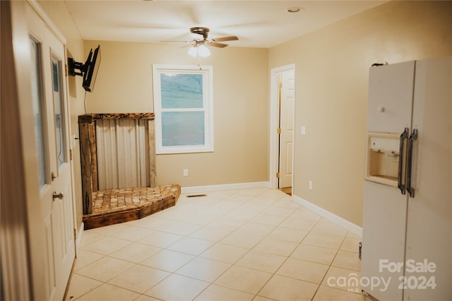 interior space with ceiling fan and light tile patterned flooring