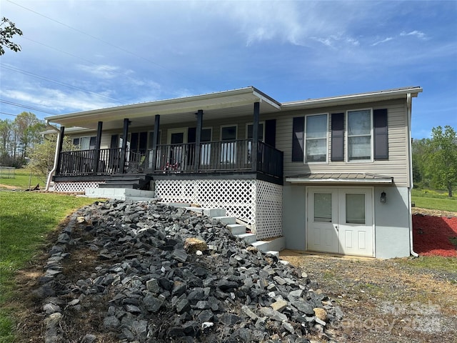 view of front of property featuring metal roof, a standing seam roof, and covered porch