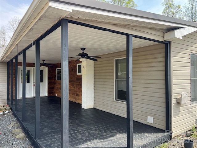 view of patio / terrace with a deck and a ceiling fan