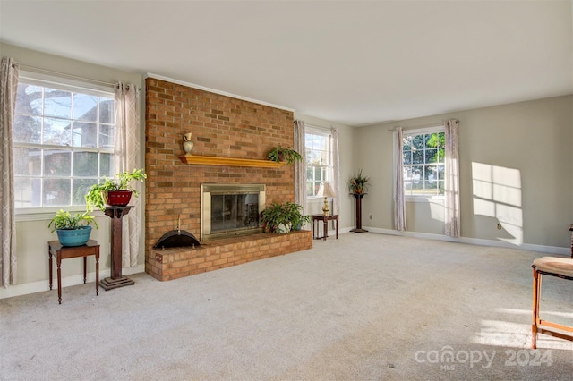 living room featuring carpet flooring, a wealth of natural light, and a fireplace