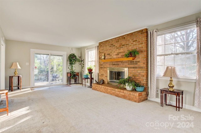 living room featuring carpet floors and a brick fireplace