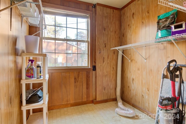 laundry area featuring wooden walls