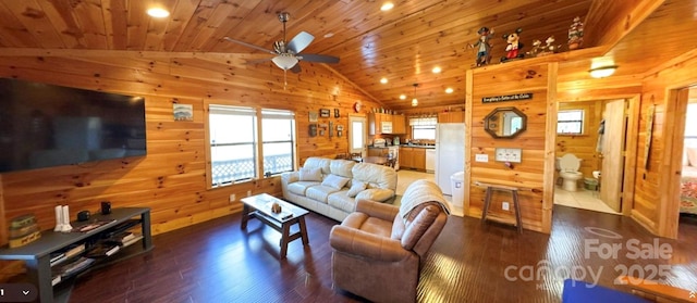 living room with lofted ceiling, wooden walls, wood ceiling, and a ceiling fan