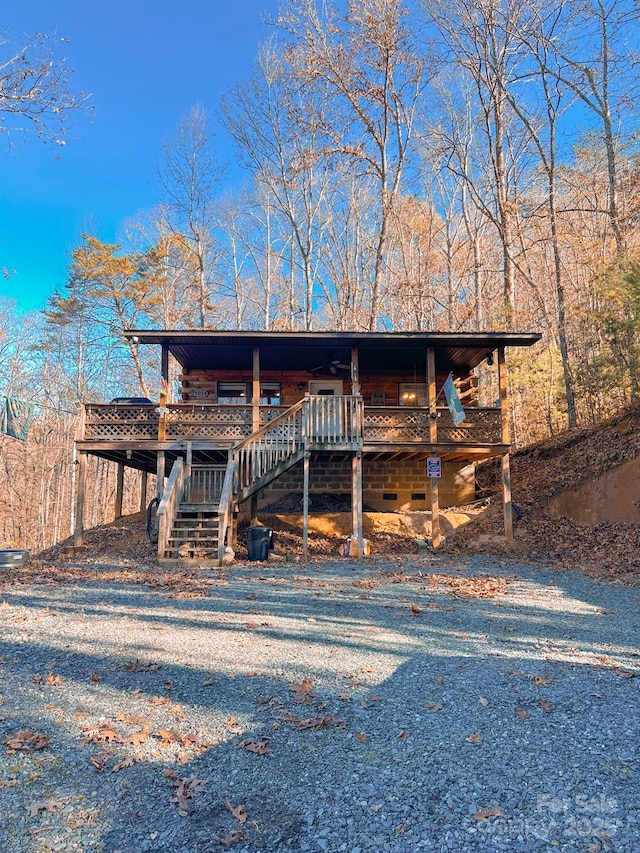 view of front of home with stairway and a wooden deck