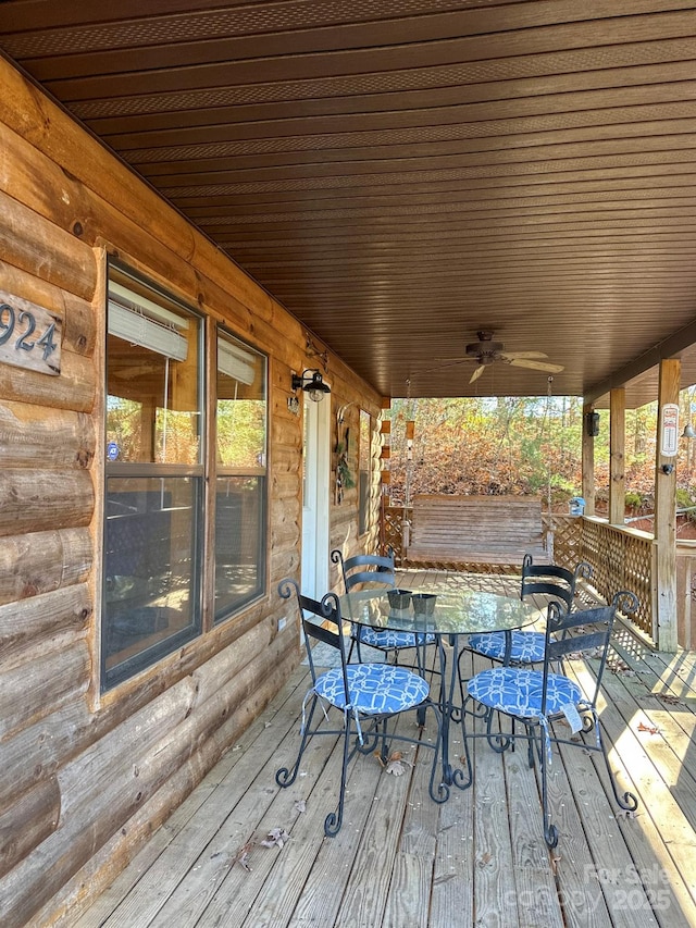 wooden deck featuring ceiling fan