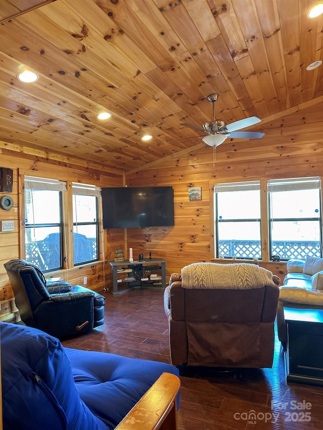 living area featuring lofted ceiling, a wealth of natural light, wooden ceiling, and ceiling fan