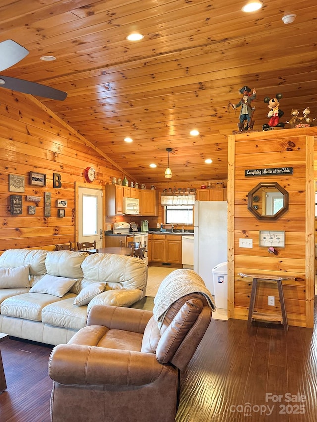 living room with a wealth of natural light, lofted ceiling, and light wood-style flooring