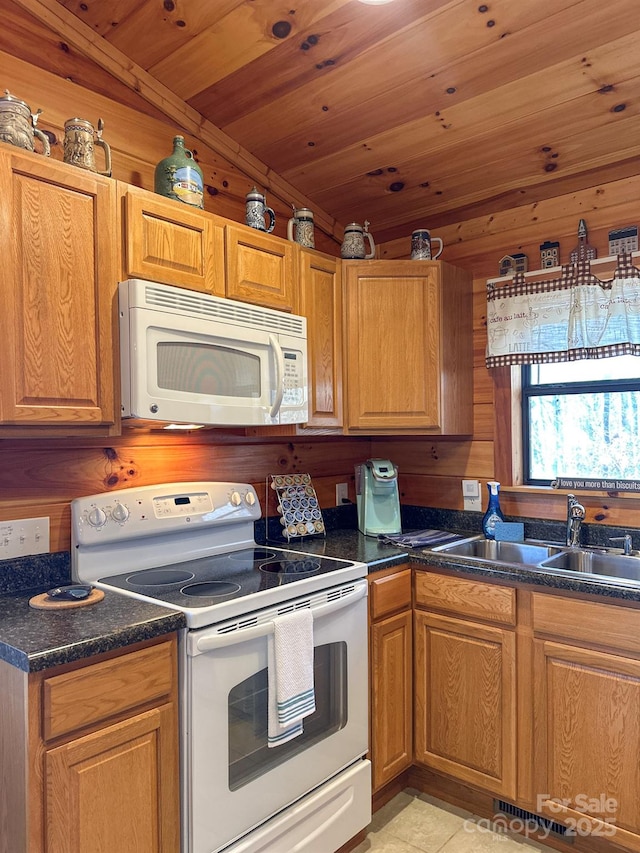 kitchen featuring dark countertops, brown cabinets, wooden ceiling, white appliances, and a sink