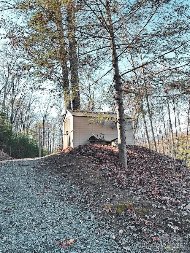 view of home's exterior featuring an outbuilding and a storage shed