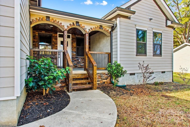 view of exterior entry featuring a porch