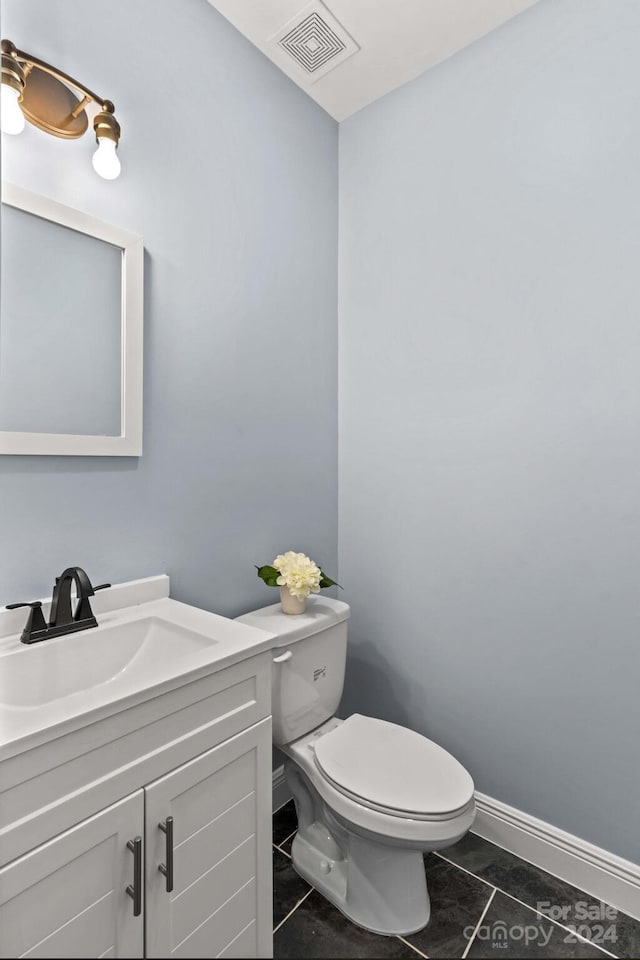 bathroom with vanity, tile patterned floors, and toilet