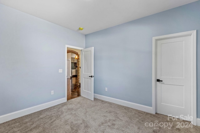 unfurnished bedroom with light colored carpet