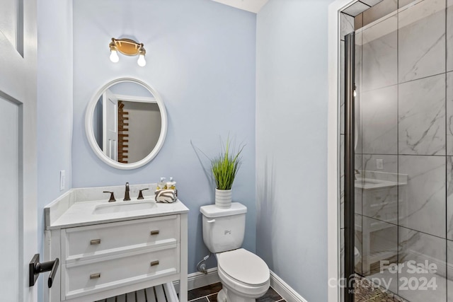 bathroom featuring vanity, toilet, and an enclosed shower