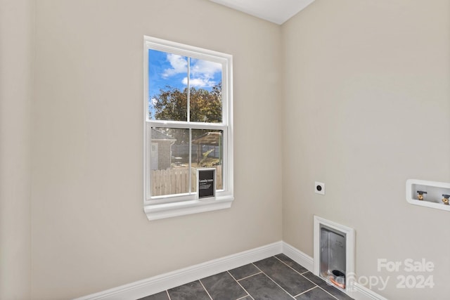 laundry area featuring hookup for an electric dryer, washer hookup, and dark tile patterned floors