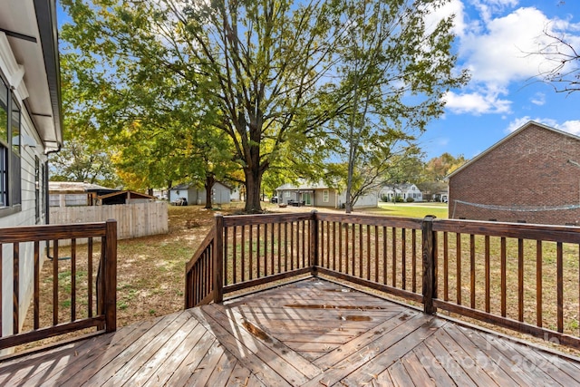 wooden terrace with a lawn