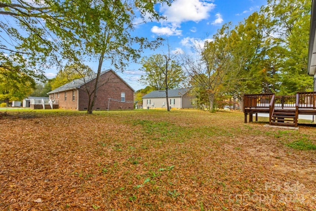 view of yard featuring a wooden deck