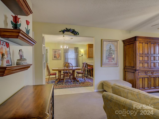 carpeted living room with a notable chandelier and a textured ceiling