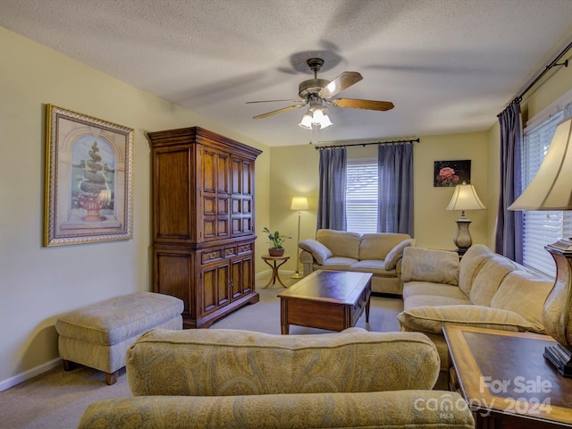 carpeted living room with a textured ceiling and ceiling fan