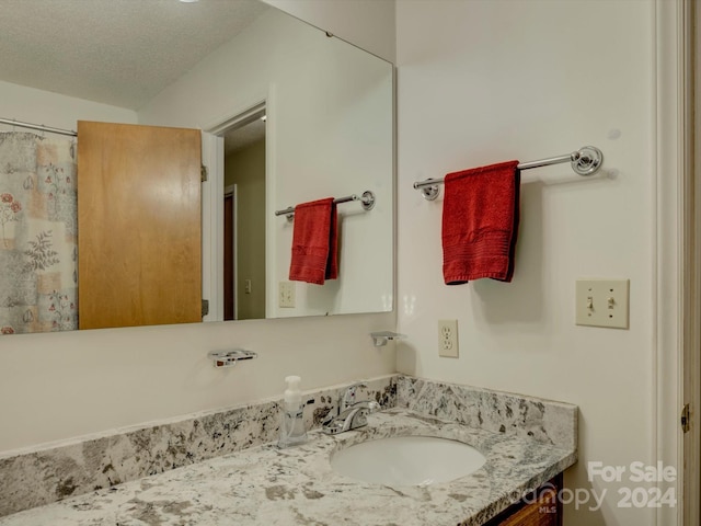 bathroom featuring vanity and a textured ceiling