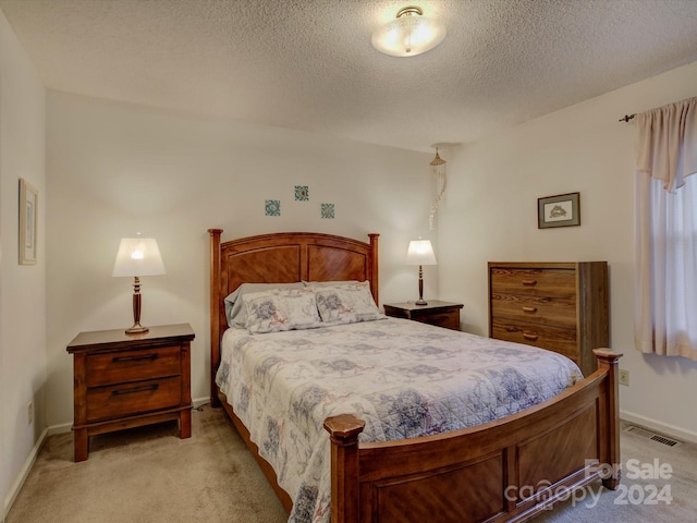 carpeted bedroom with a textured ceiling