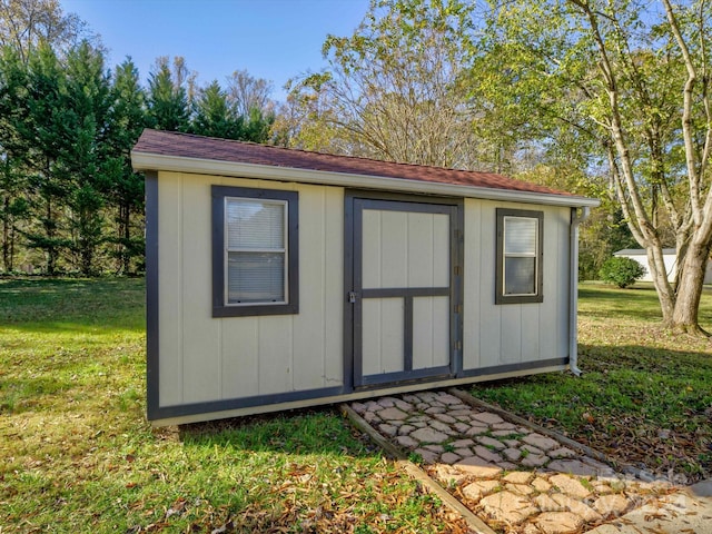 view of outbuilding with a yard