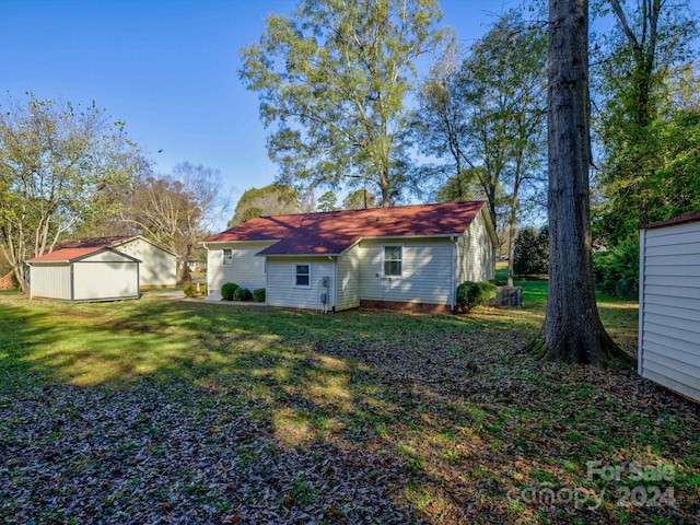 back of property with a lawn