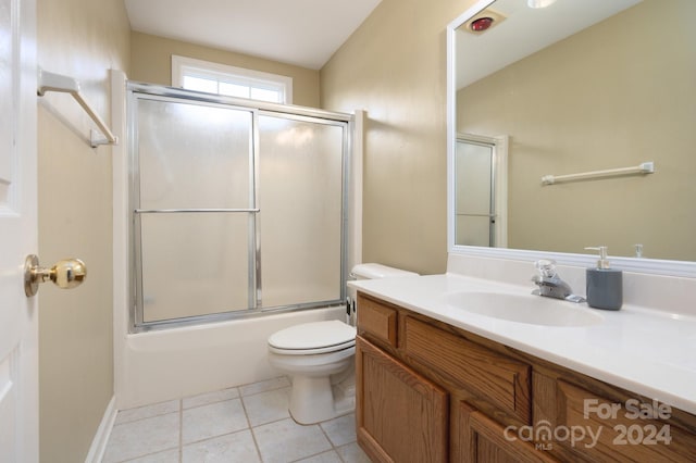 full bathroom featuring tile patterned flooring, toilet, combined bath / shower with glass door, and vanity