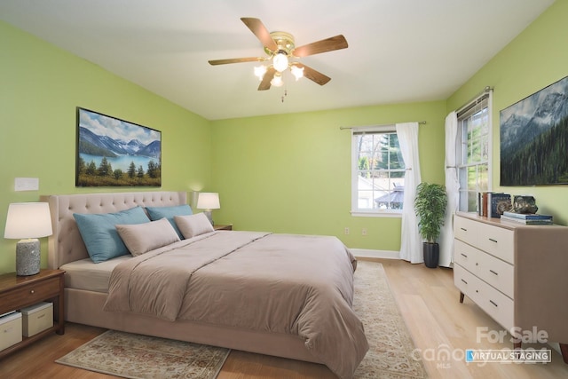 bedroom with ceiling fan and light hardwood / wood-style flooring