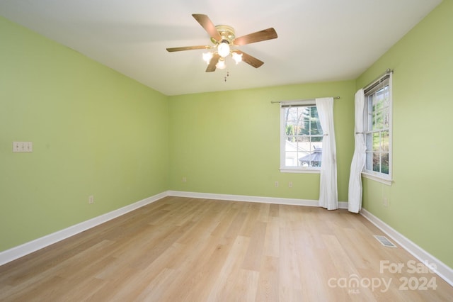 spare room with ceiling fan and light hardwood / wood-style flooring