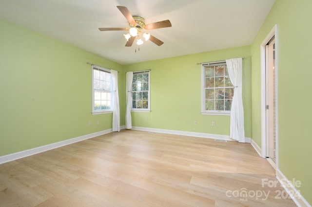 spare room featuring ceiling fan and light hardwood / wood-style flooring