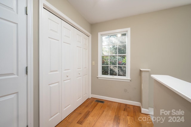 hall with light hardwood / wood-style flooring