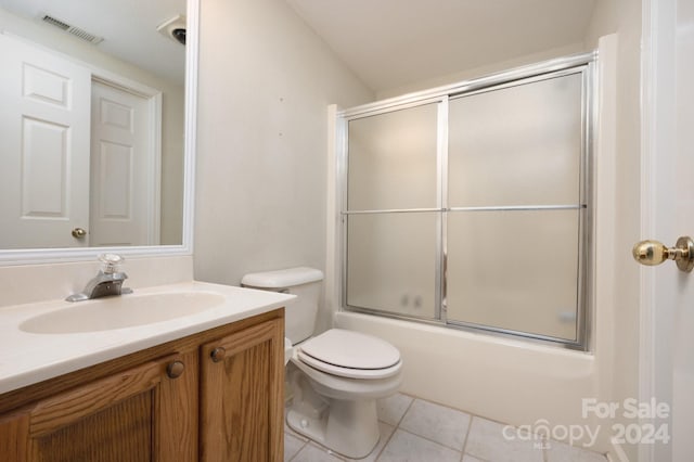 full bathroom with tile patterned flooring, vanity, toilet, and shower / bath combination with glass door