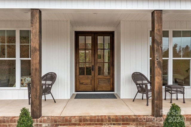 property entrance featuring french doors and covered porch