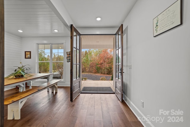 doorway to outside with dark wood-type flooring and french doors